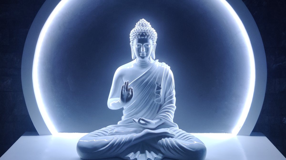 
a backlit buddha statue depicting wisdom and a state of enlightenment
