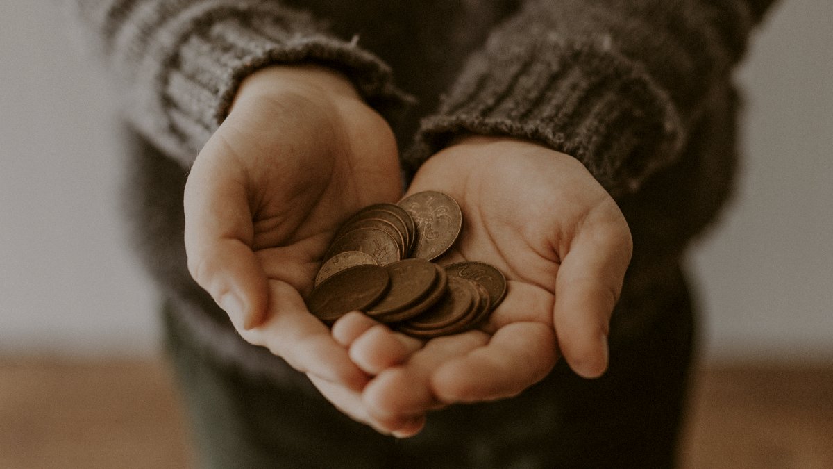 
a-child-holding-coins
