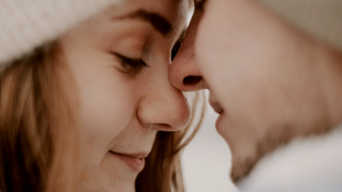 
a close up of a couple brushing their noses against each other
