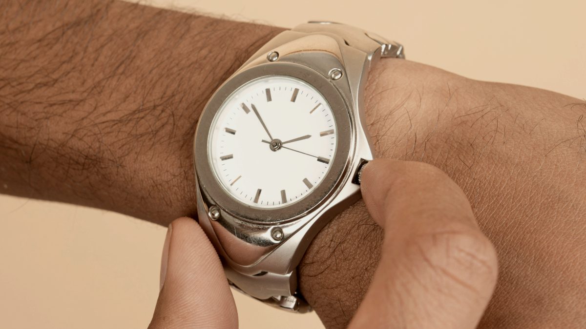 
A close up of a person holding a watch
