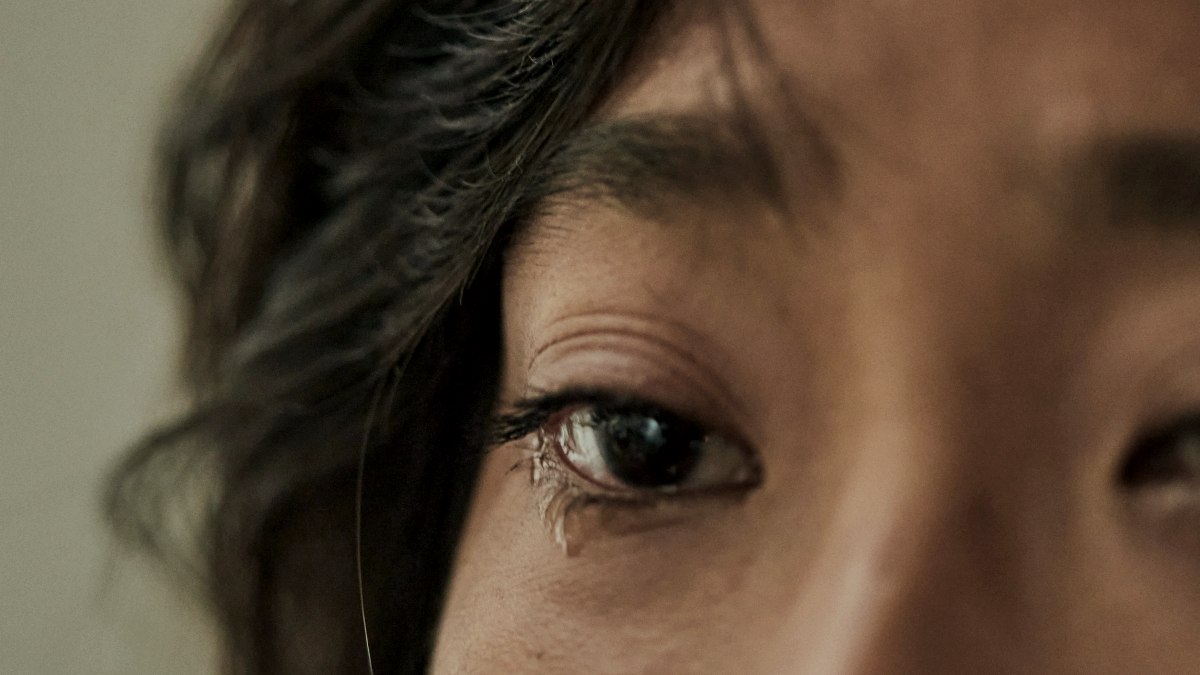 
a close up of a woman's face with a concerned look on her face
