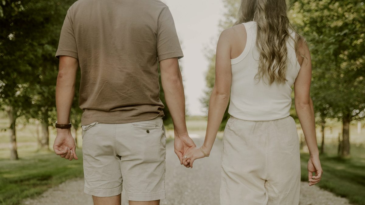 
a-couple-holding-hands-on-a-scenic-walk
