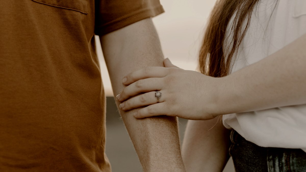 
a couple holding hands while standing next to each other by brooke cagle
