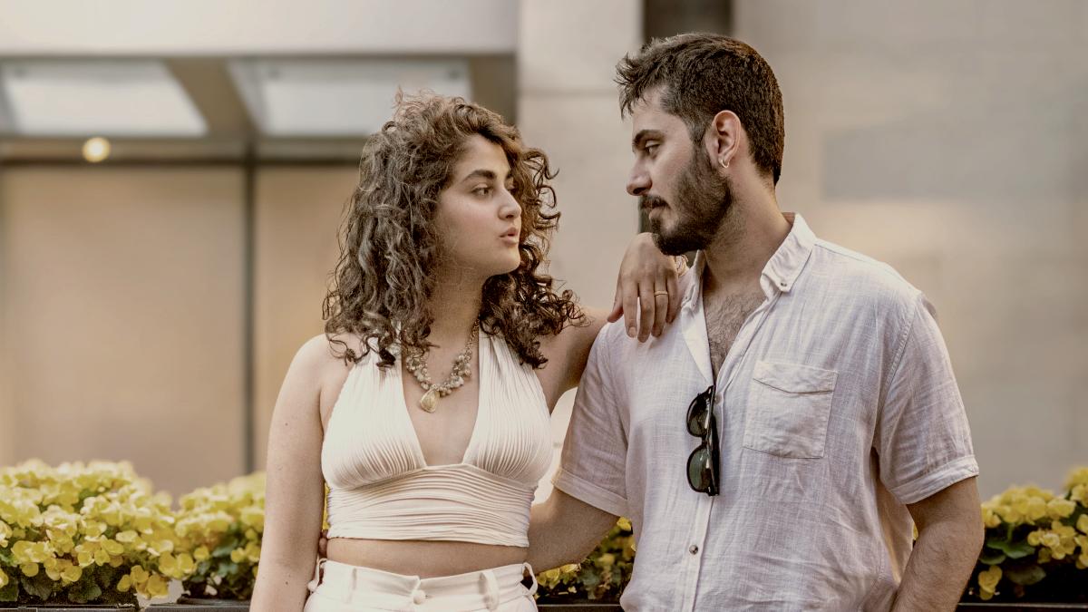 
A couple poses together outdoors, looking at each other by Lumière Rezaie
