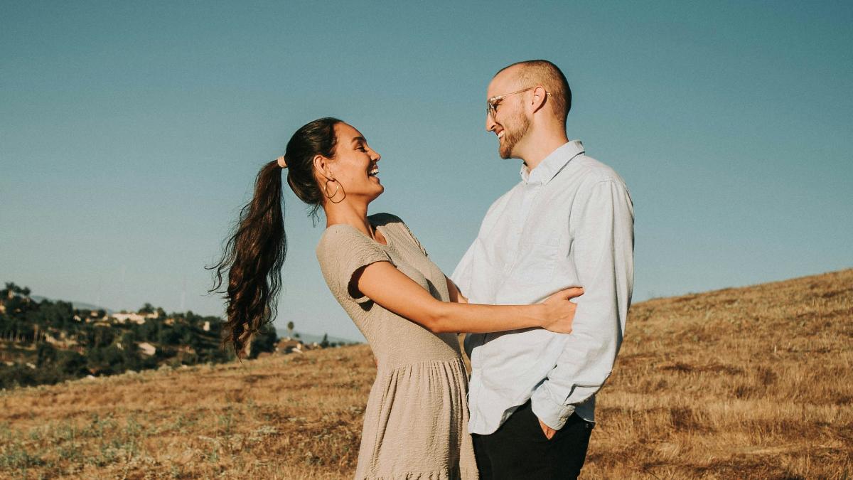 
a-couple-sharing-a-joke-while-embracing
