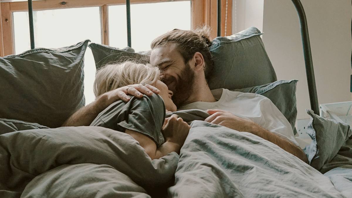 
a-couple-snuggling-in-bed-together
