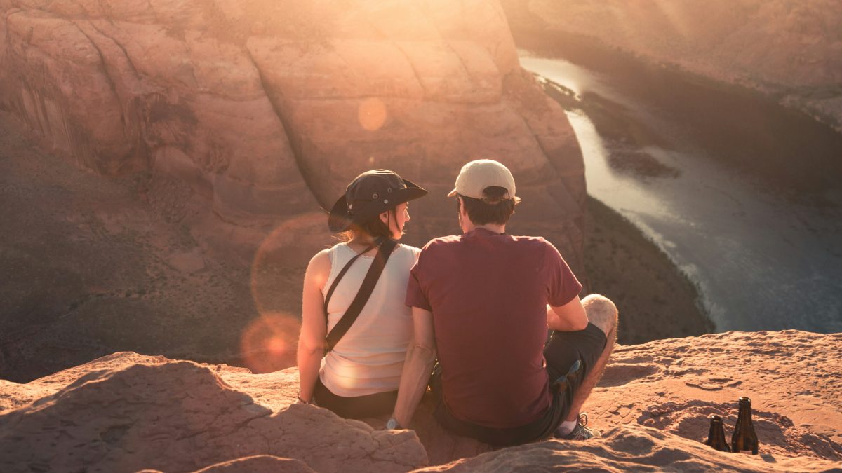 
a-couple-talking-on-a-cliff-at-sunset

