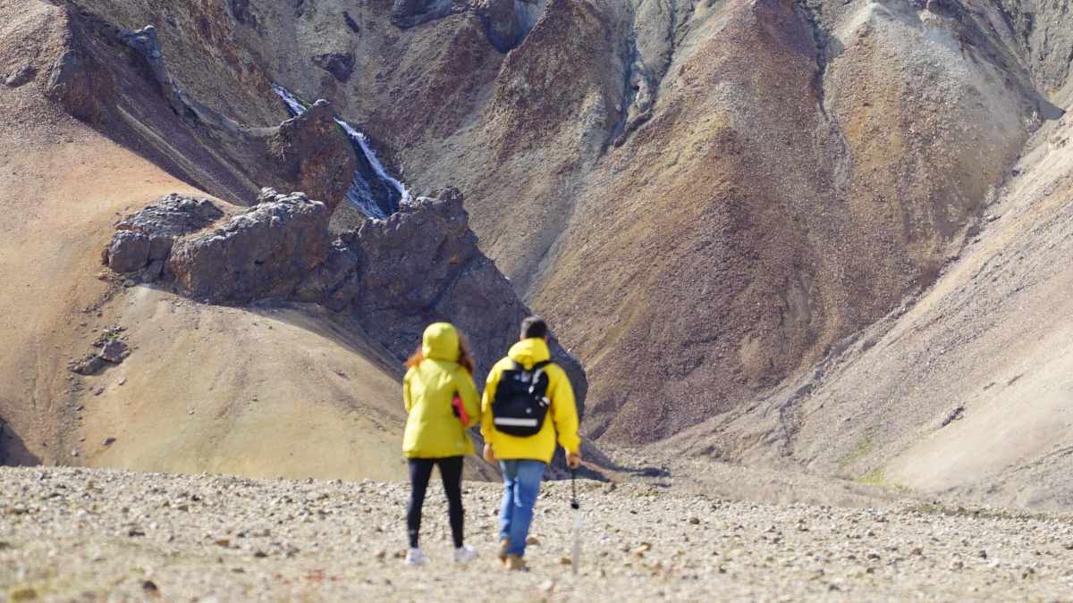 
a couple wandering around in an awe inspiring landscape experiencing self-transcendent moments
