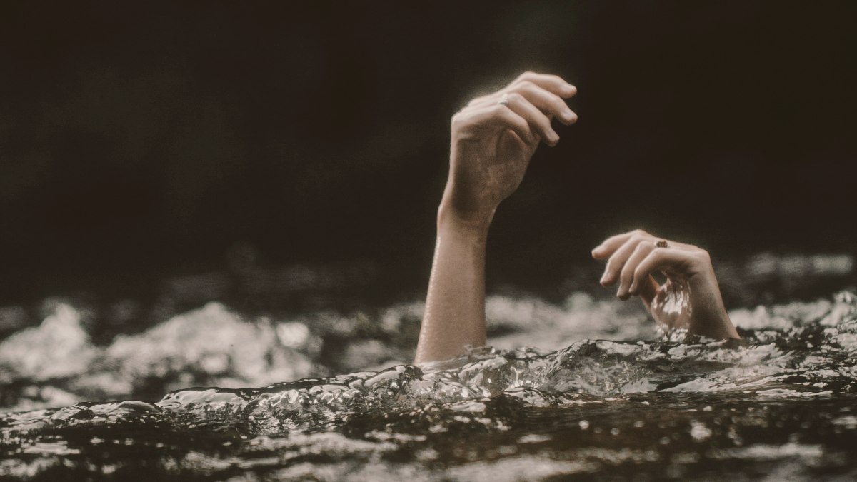 
a-drowning-person-reaching-for-help
