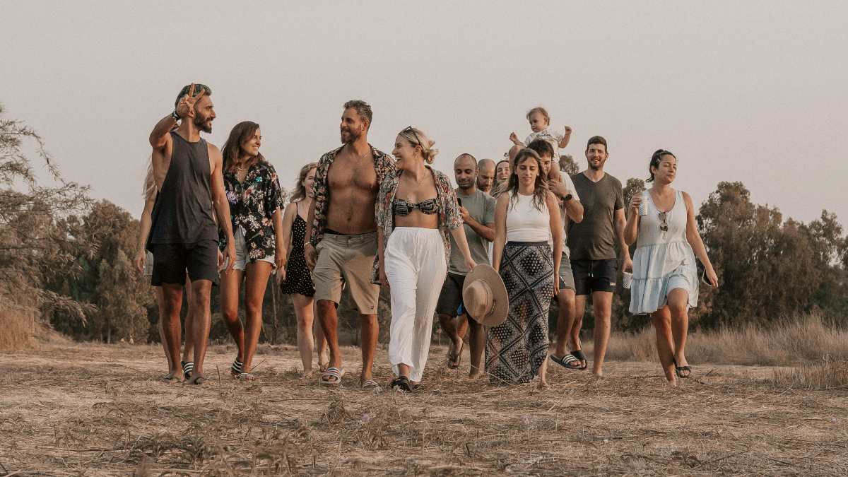 
a group of people walking along a dirt road
