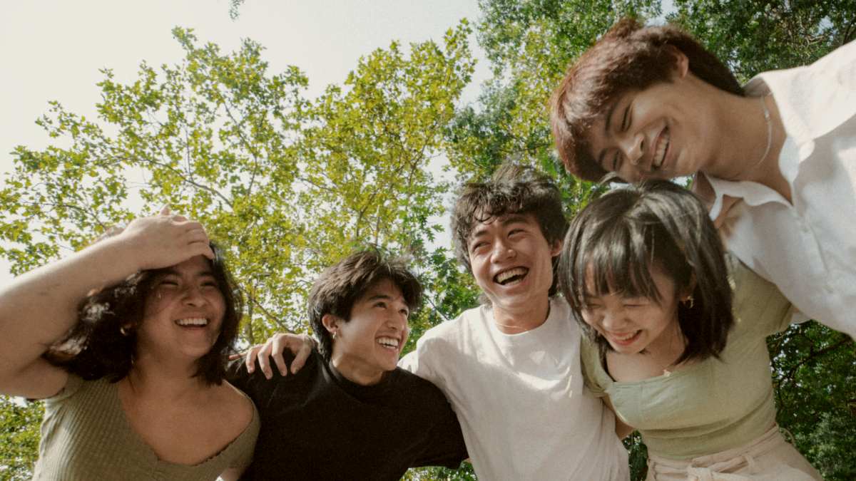 
a group of young people standing next to each other
