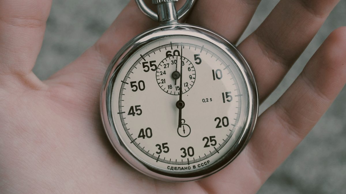 
a hand holding a stopwatch
