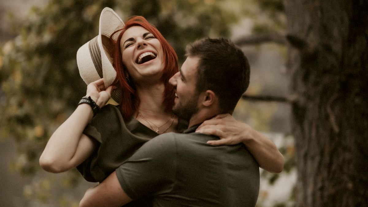 
a-happy-couple-laughing-together-at-the-lake
