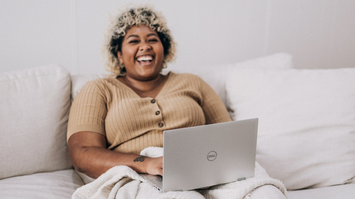 
a-happy-woman-smiling-on-a-cozy-couch
