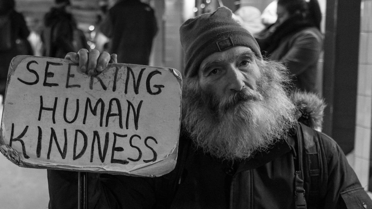 
a homeless man posing for social media and asking strangers to show him kindness
