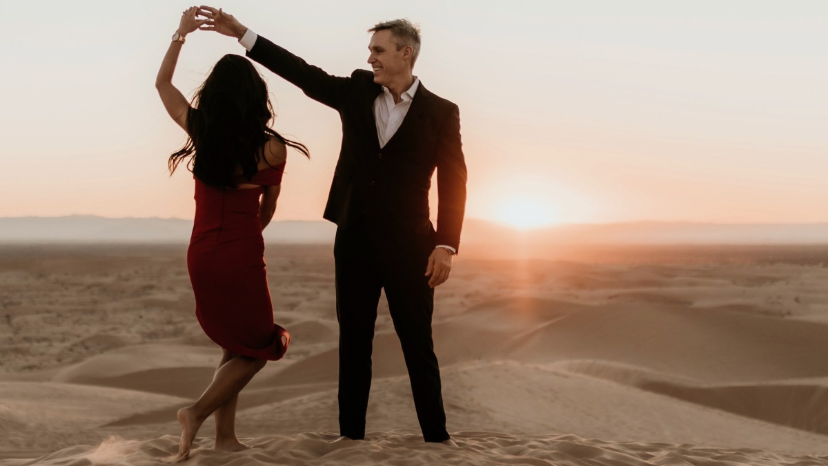
a-husband-and-wife-dancing-in-the-desert

