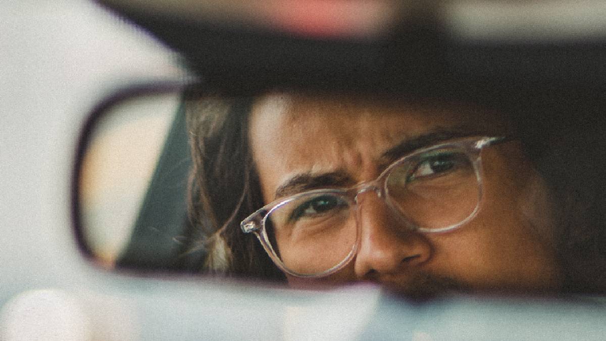 
a male auto driver looking upset about something that has happened on the road
