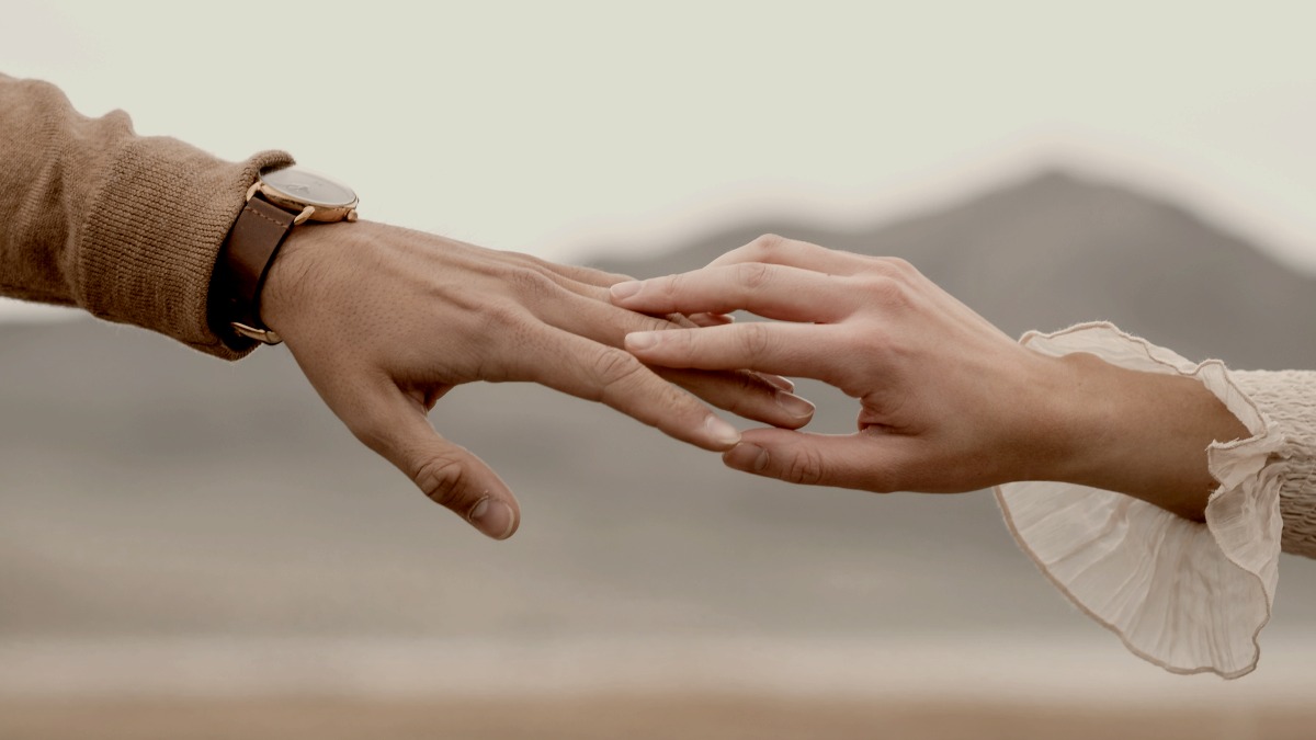 
a male hand and female hand touching showing love by The Chaffins

