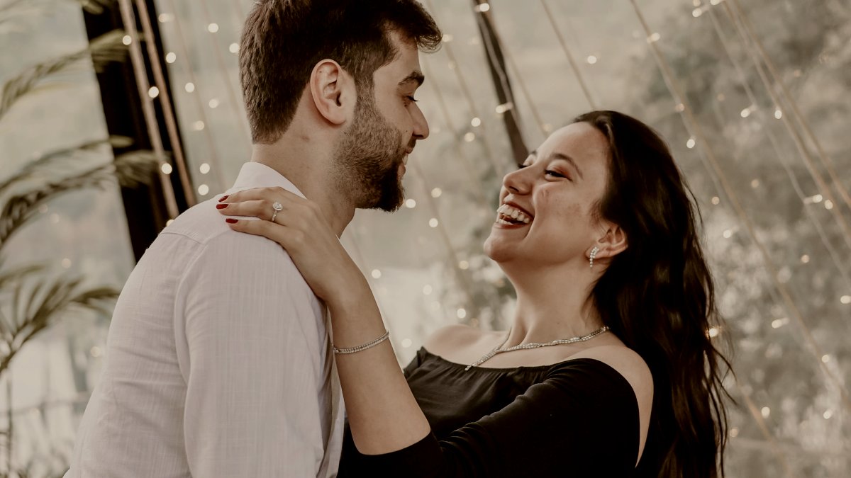 
a man and a woman looking at each other laughing by Aliburhan S
