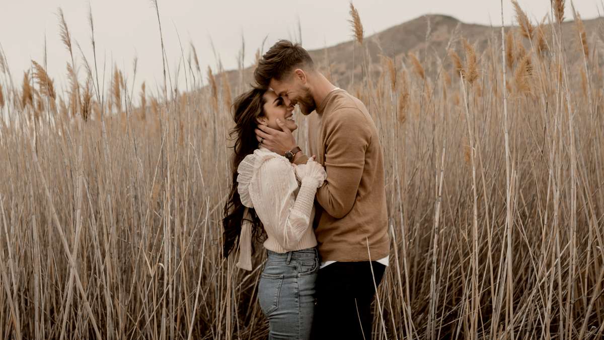 
a-man-and-a-woman-standing-in-a-field-of-tall-grass
