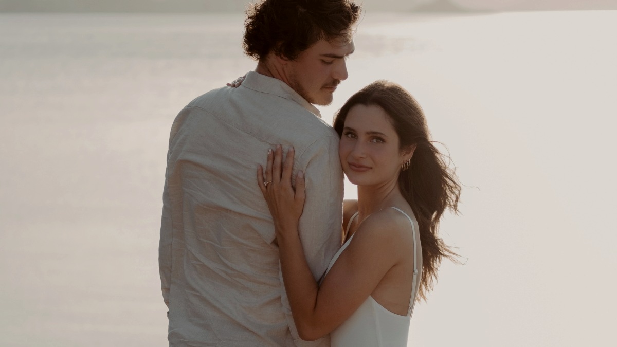 
a-man-and-a-woman-standing-next-to-each-other-on-a-beach
