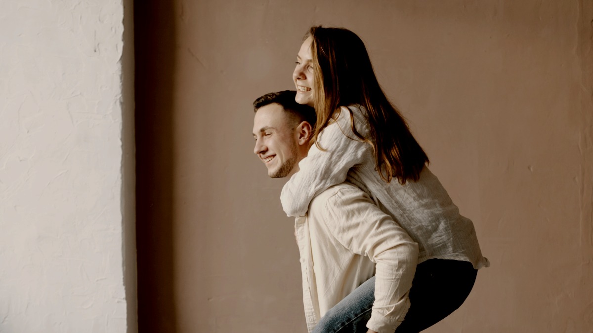 
a man and a woman standing on a rug with the man carrying woman by Kateryna Hilznitsova
