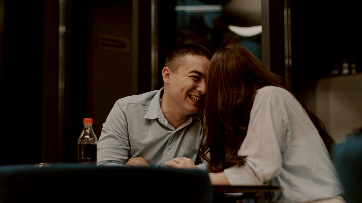 
A man and woman sitting at a table in a restaurant by Kateryna Hliznitsova
