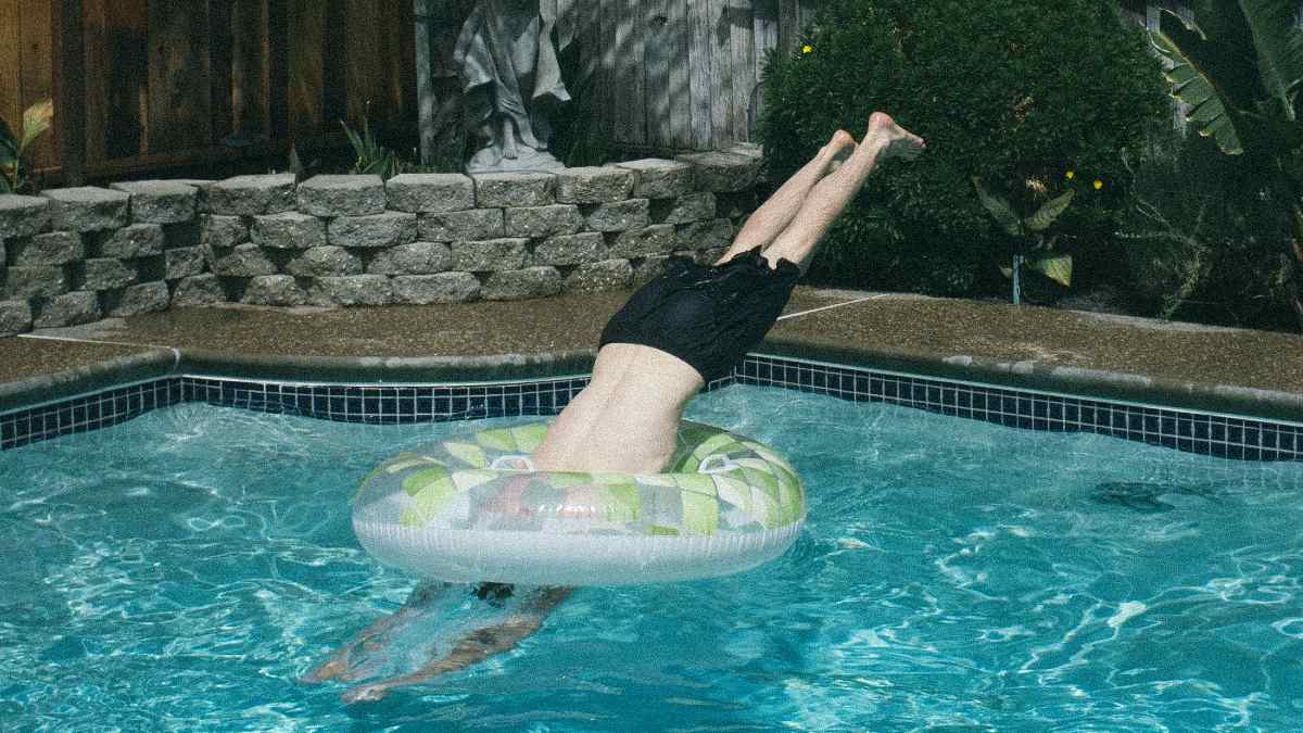 
a man diving into a pool as a metaphor for entering a new state of mind
