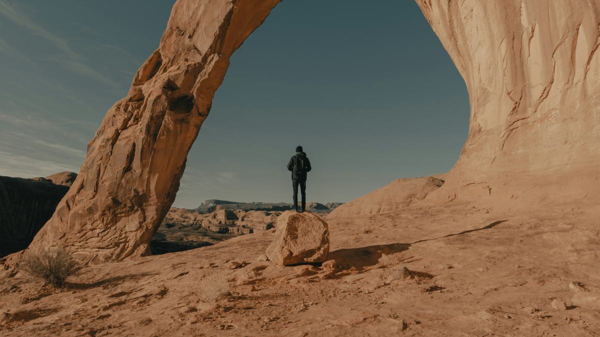 
a-man-hiking-through-the-desert
