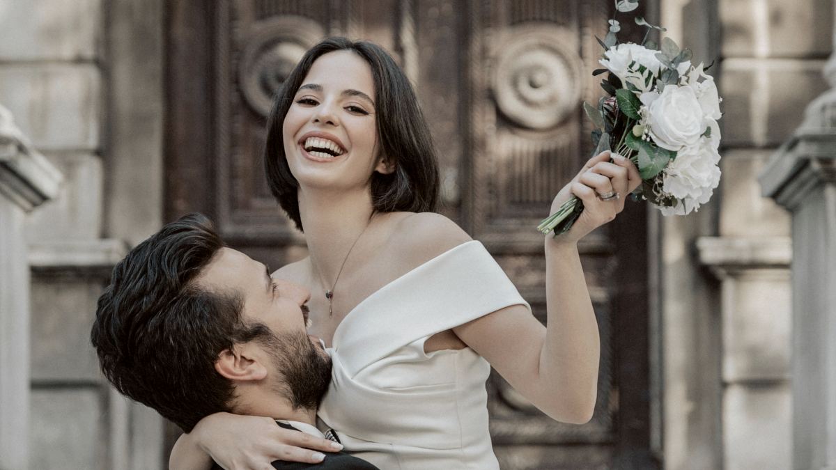 
a man holding a bouquet of flowers next to a woman
