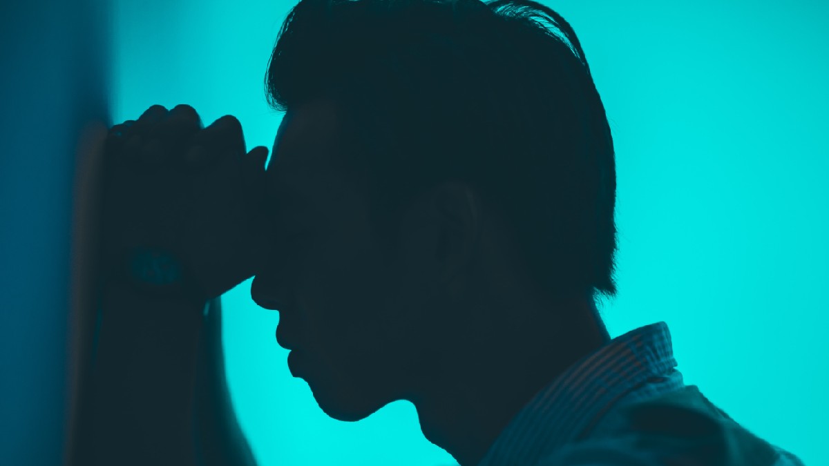 
A man holding his head because he is anxious and psychologically unstable.
