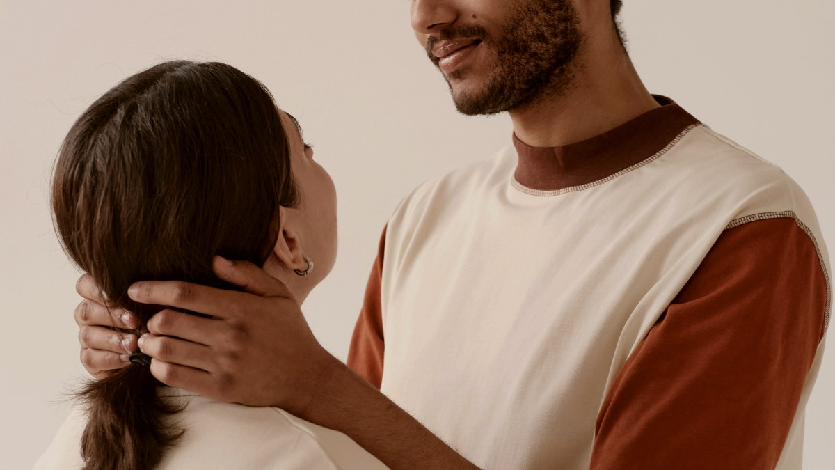 
A man holding his partner by the neck in an embrace
