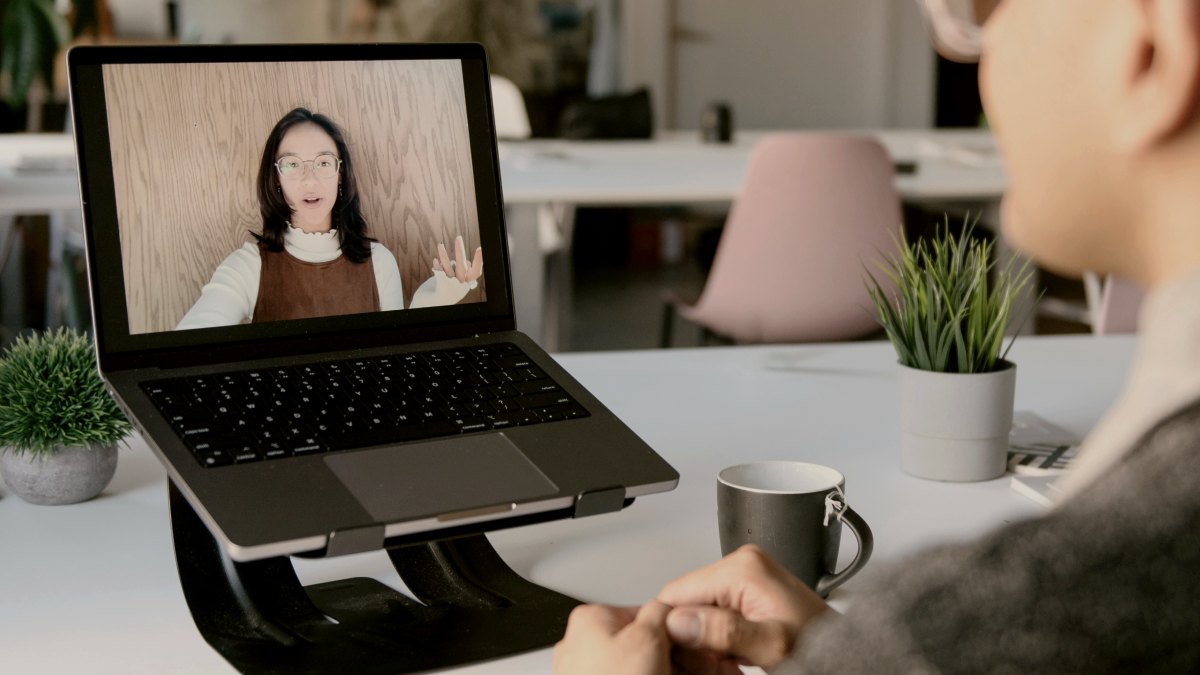 
a man on facetime on a laptop with his friend
