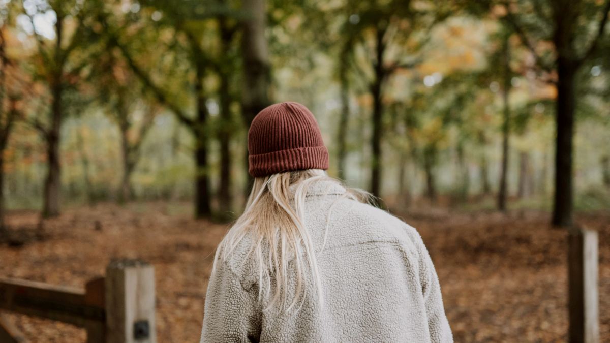 
a man with long white hair and red beanie walking in the woods by Frank van Hulst
