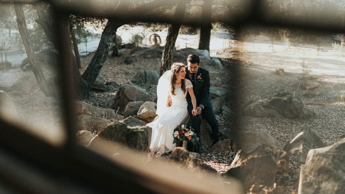 
a-married-couple-sitting-on-a-rock
