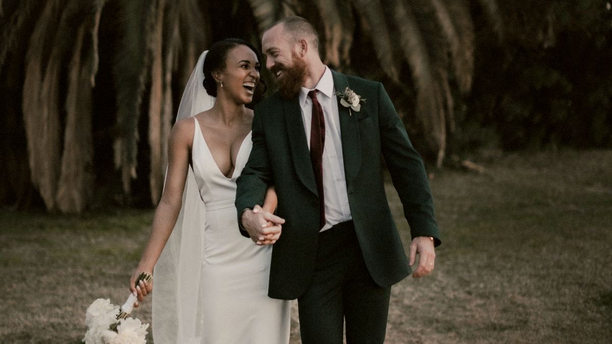 
a-newly-wed-couple-laughing-with-one-another
