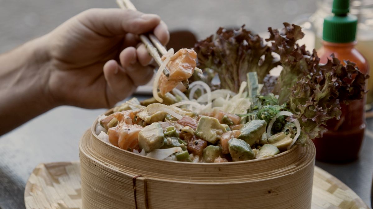 
a-person-eating-a-poke-bowl
