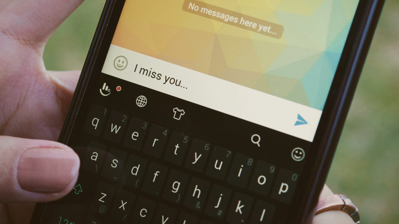 
a person holding a cell phone in their hand with text message saying I miss you by Behzad Soleimanian
