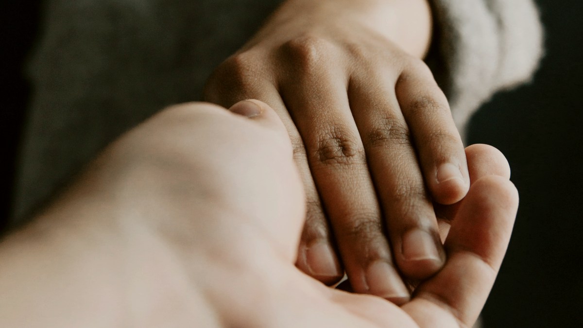 
a person holding the hand of another person
