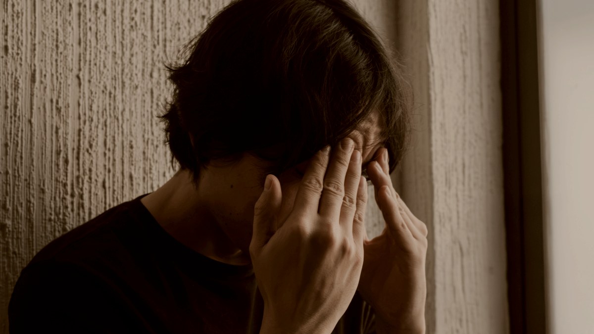 
A person standing in front of a window holding their hands to their face by Mariela Ferbo
