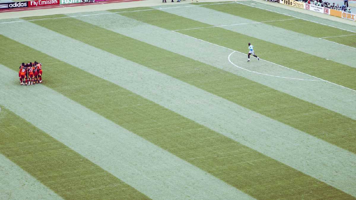 
a soccer team on a soccer field showing great teamwork and mental toughness
