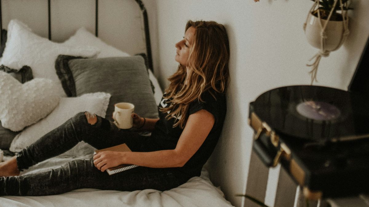 
a-stressed-woman-leaning-on-her-bedroom-wall
