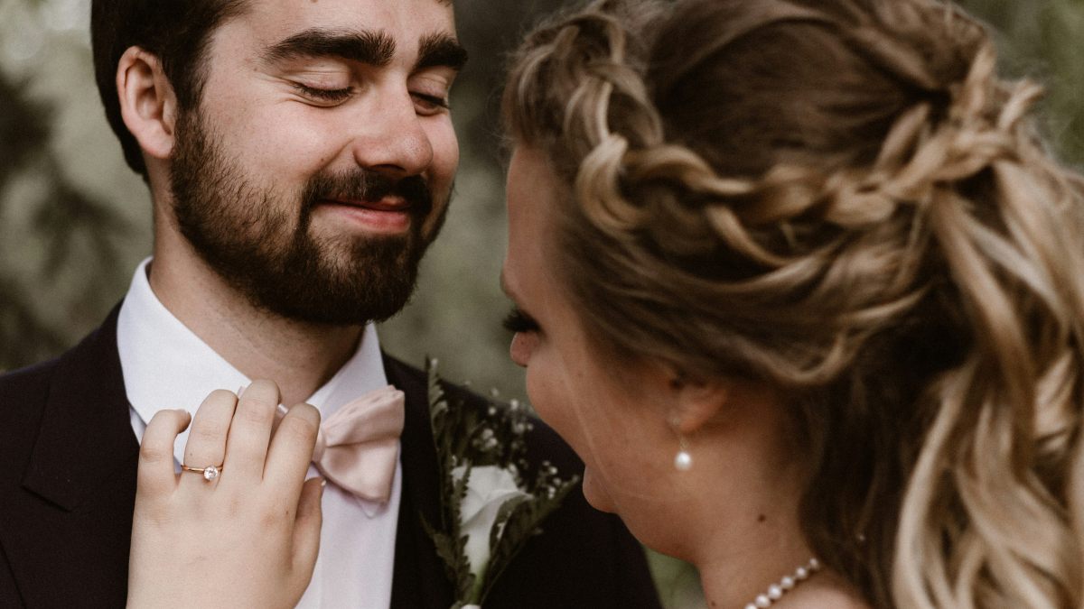 
a-woman-fixing-her-husbands-bowtie
