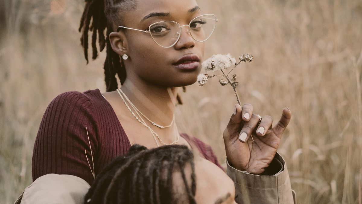 
a-woman-holding-a-flower-as-she-cradles-her-boyfriend
