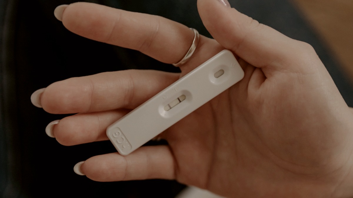 
a-woman-holding-a-positive-pregnancy-test
