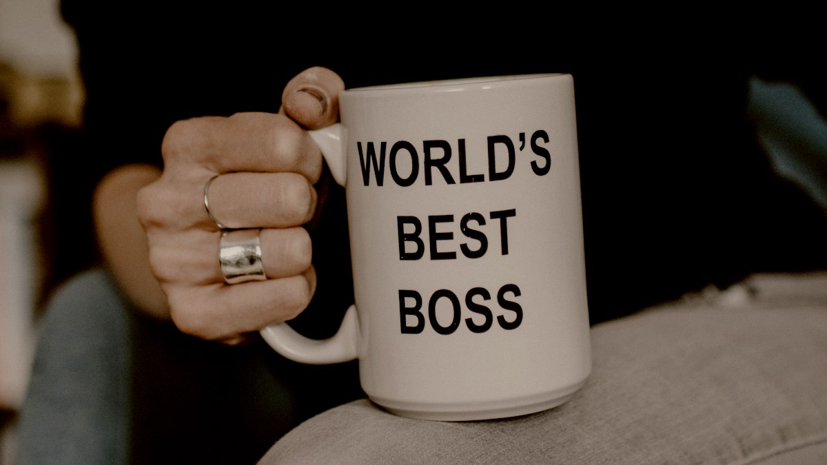 
a-woman-holding-a-worlds-best-boss-mug
