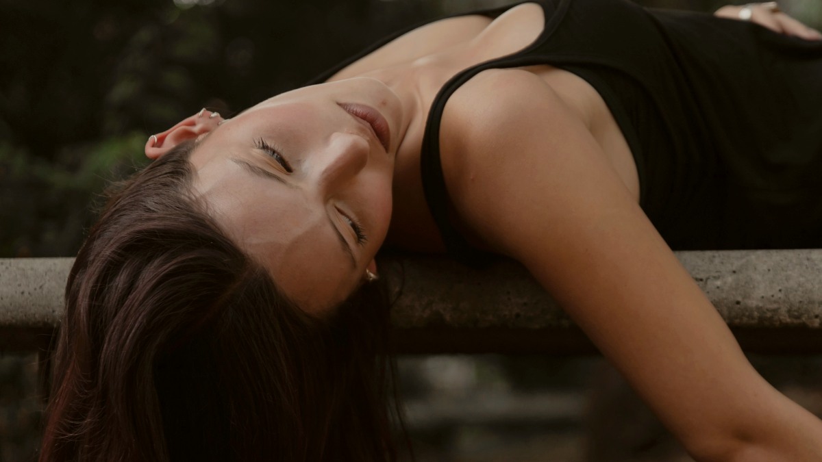 
A woman in a black dress laying on a bench by  pablo merchan montes
