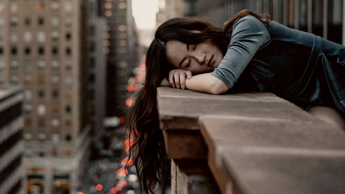 
a woman overthinking on her balcony
