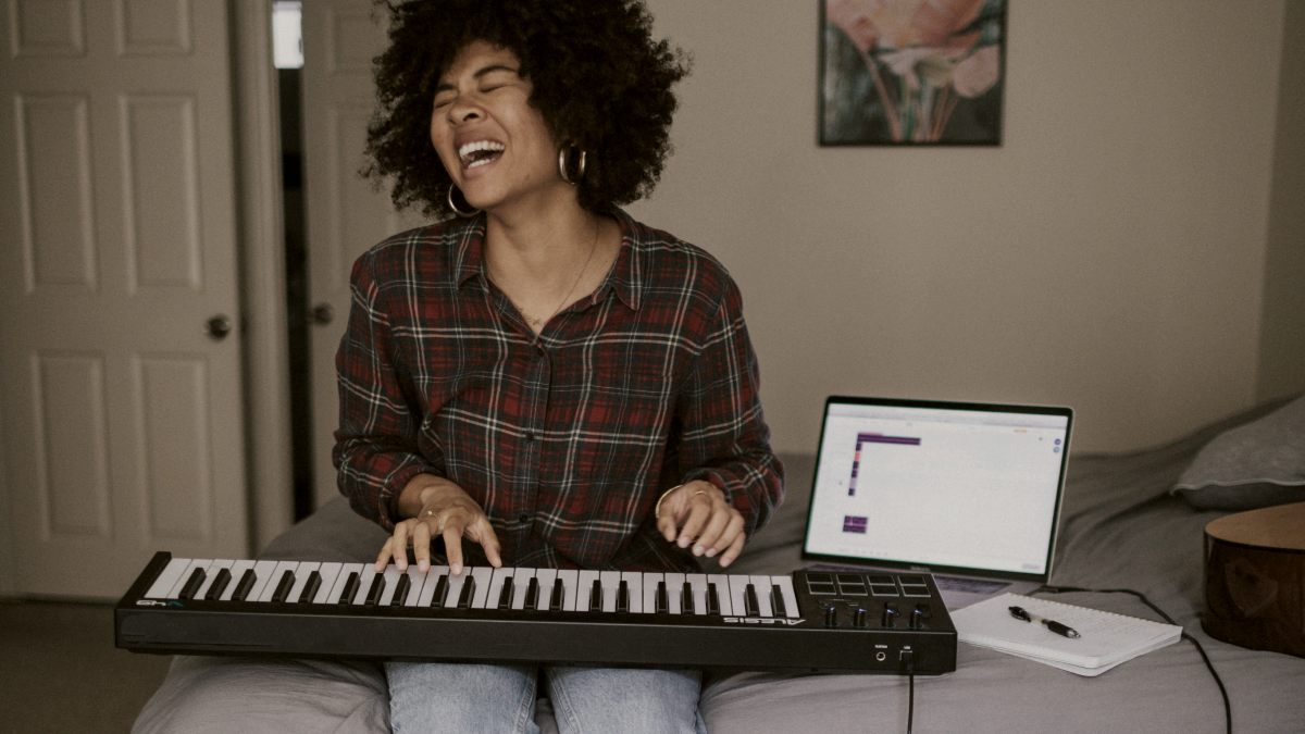 
a-woman-singing-and-playing-keyboard
