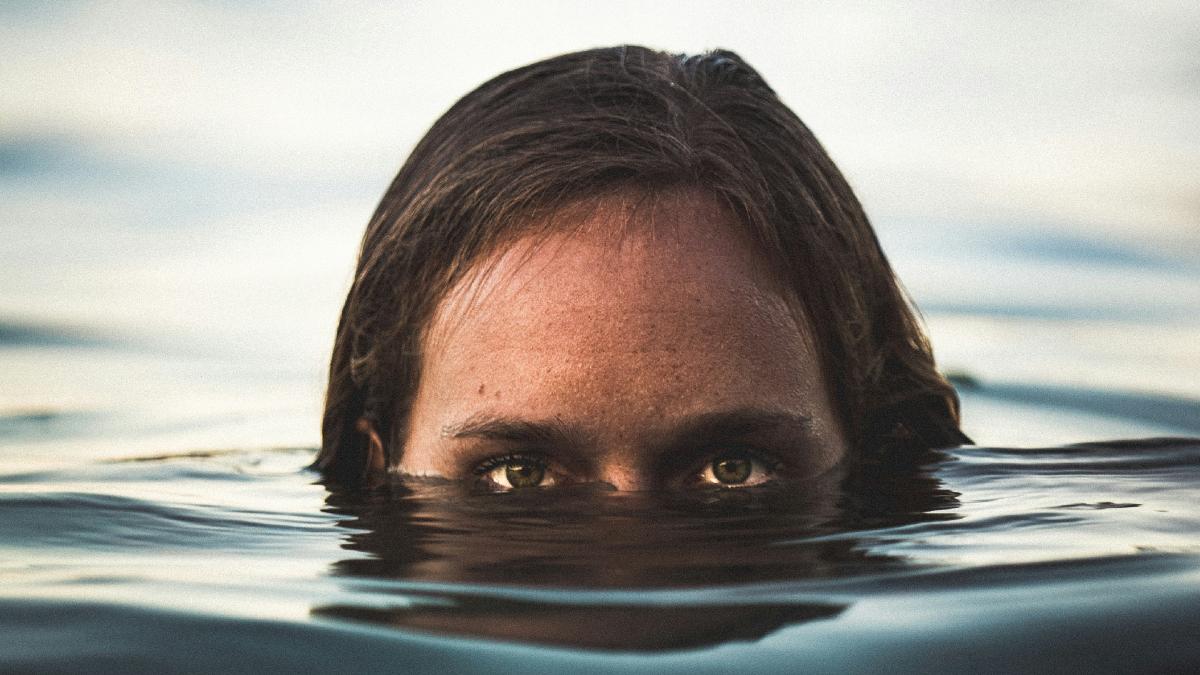 
a woman submerged in eerie water
